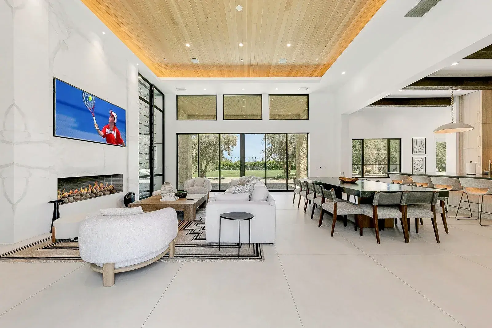 The great room with fireplace and views to the lawn