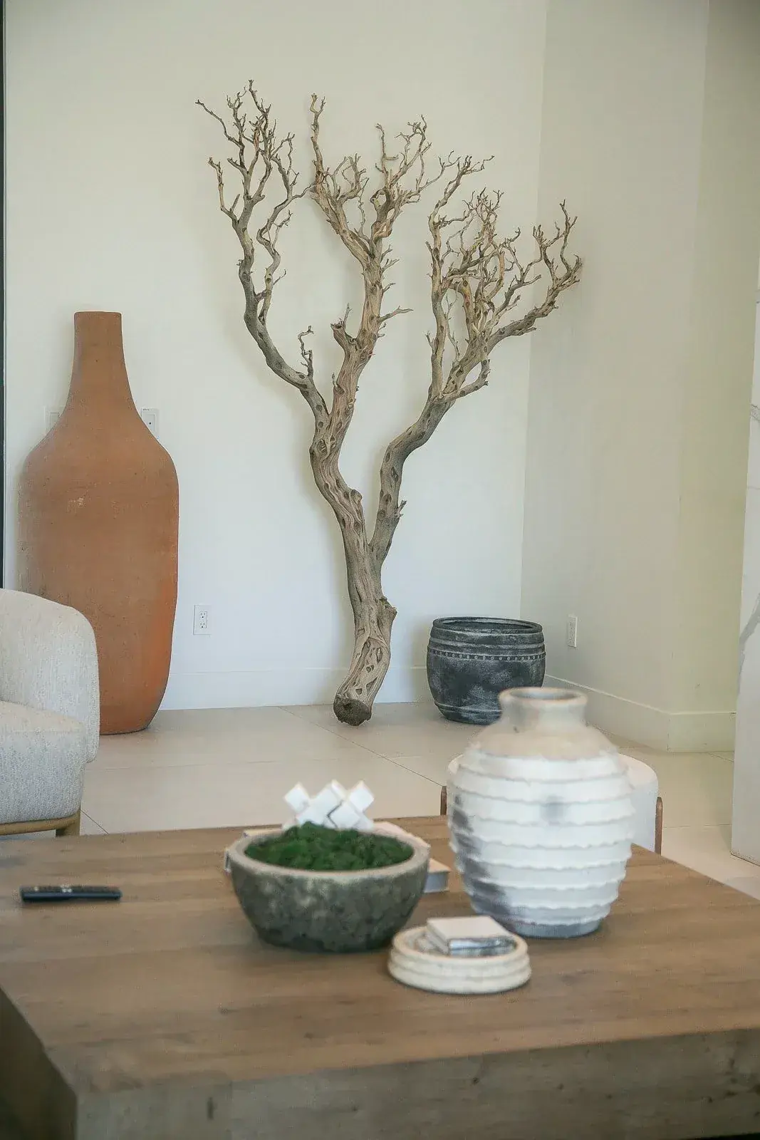 Interior still life with stone vessel and branch